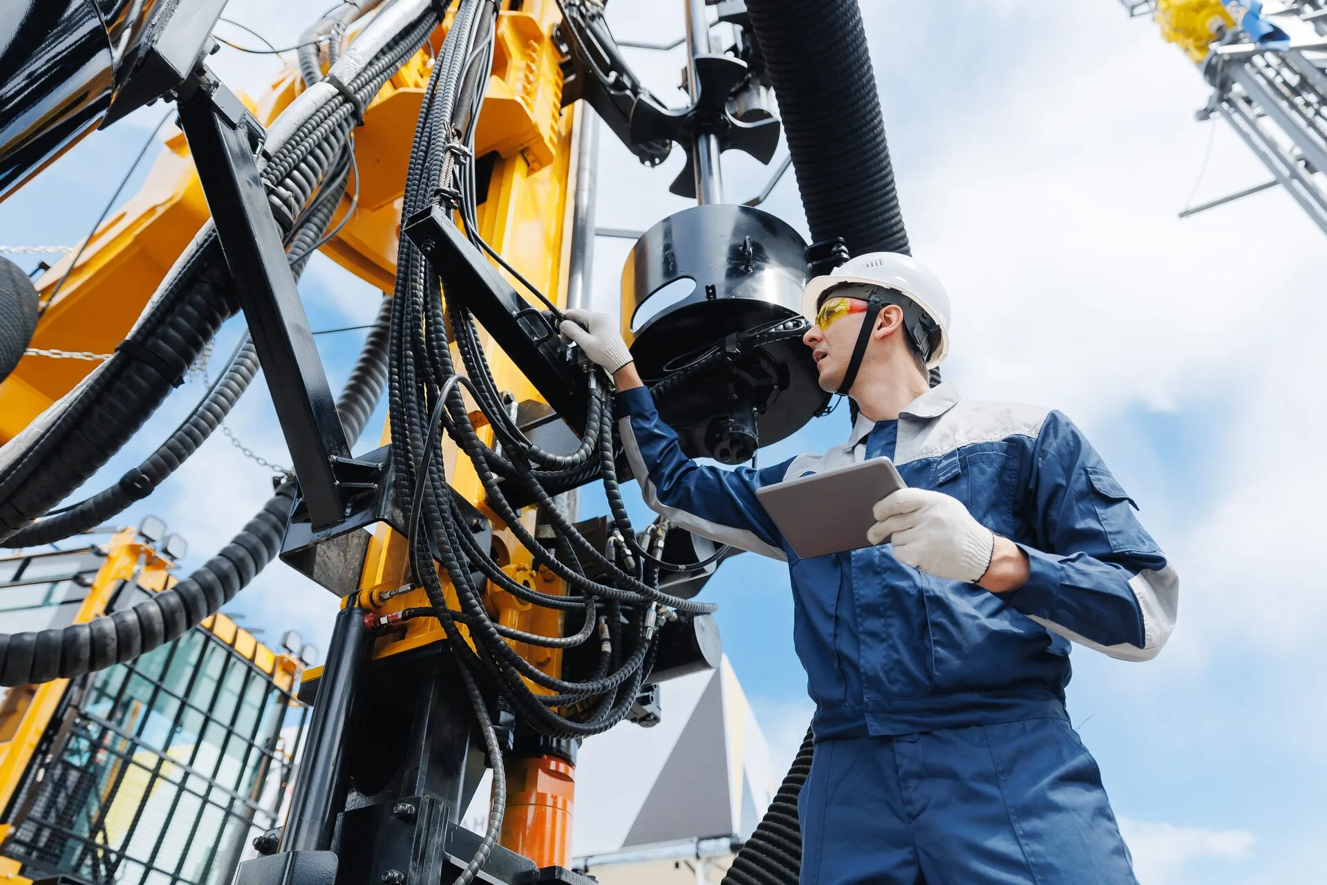 Field technician using digital tablet for safety inspections